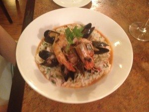 Shrimp, lobster, calamari and muscles with lemon and herbs in a parsley broth. 