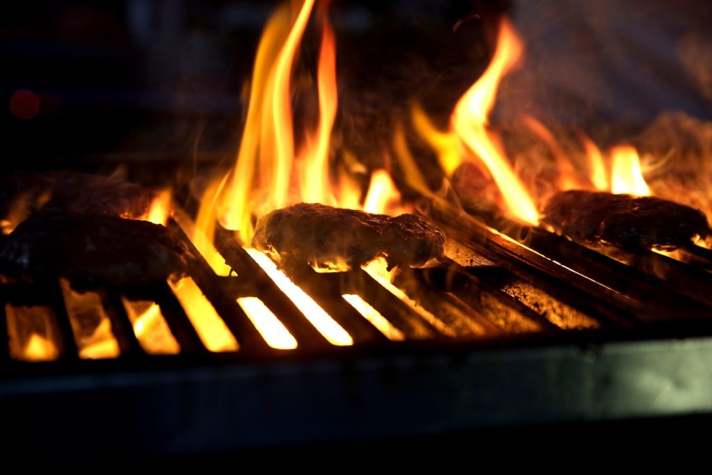 NEW YORK, NY - OCTOBER 16: Burgers cook on a grill during the Blue Moon Burger Bash presented by Pat LaFrieda Meats hosted by Rachael Ray - Food Network & Cooking Channel New York City Wine & Food Festival presented by FOOD & WINE at Pier 92 on October 16, 2015 in New York City. (Photo by Neilson Barnard/Getty Images for NYCWFF)